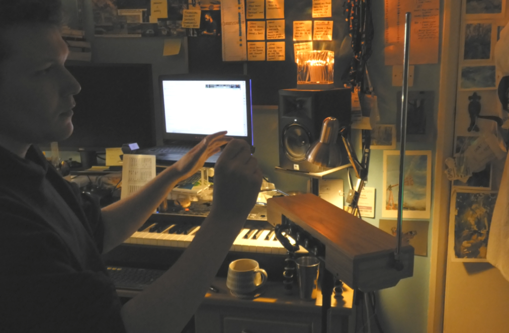Screenshot-2025-06-21-195351-1.webp Studio action shot of Felix performing parts on theremin.